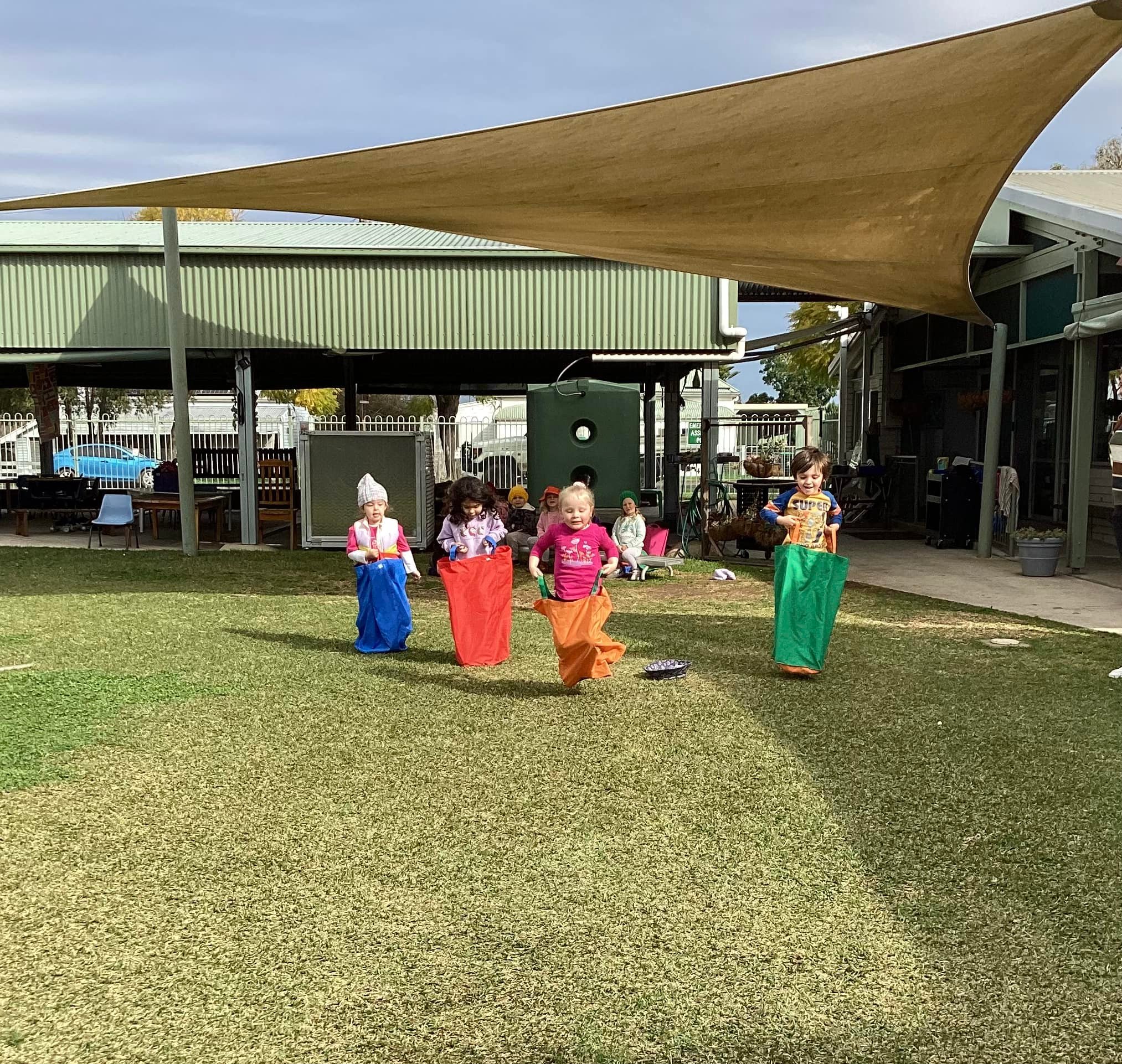 Early Childhood Centre Children playing in a sack race at the Aberdeen Pre-School - Early Childhood Centre of excellence in the local community.